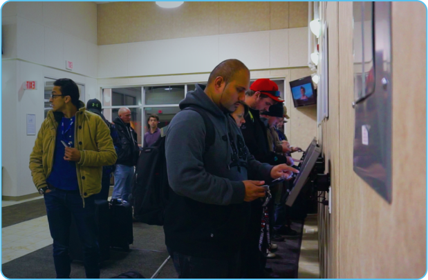 Camp residents complete kiosk check-in at lobby of a remote fly-in fly-out camp.